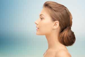 Profile view of a young brunette woman with a cute, feminine nose