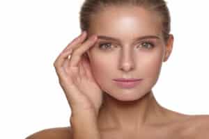 Woman touches her smooth forehead following a brow lift